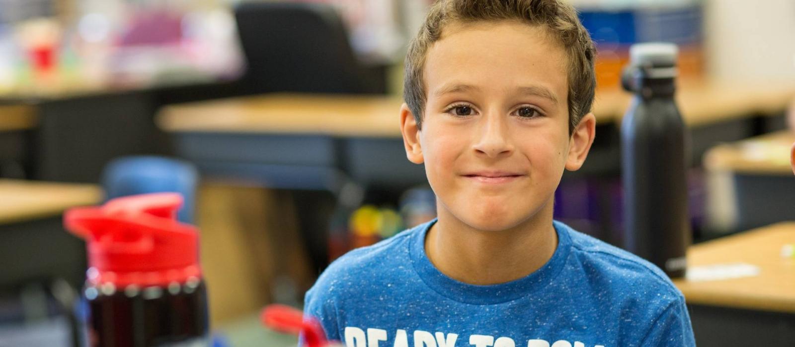 Elementary student smiling in classroom